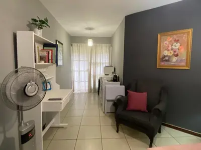 a living room with a desk and a chair at Serene Garden Suite in Pretoria