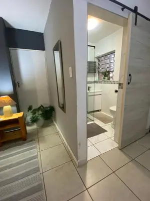 a bathroom with a shower and a glass door at Serene Garden Suite in Pretoria