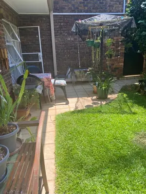 a patio with a bench and a swing at Serene Garden Suite in Pretoria