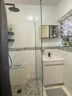 a bathroom with a shower and a sink at Serene Garden Suite in Pretoria