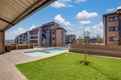a small tree in a yard in front of a building at GroundEazy beside Mall of Africa in Midrand