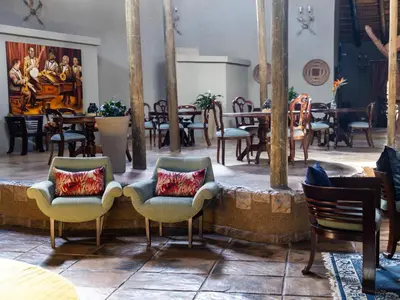 a restaurant with chairs and tables in a room at Oluchi Lodge in Guthrie