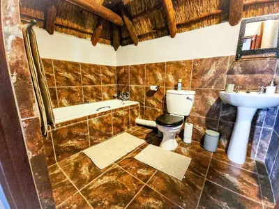 a bathroom with a toilet and a sink at Villa Zizi in Bela-Bela in Moheme
