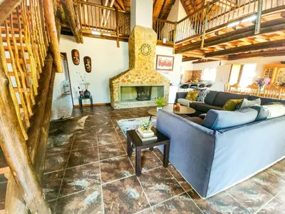 a living room with a couch and a fireplace at Villa Zizi in Bela-Bela in Moheme