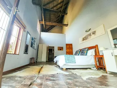 a bedroom with a bed in the middle of a room at Villa Zizi in Bela-Bela in Moheme