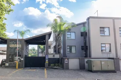 a building with a palm tree in front of it at Pamuzinda Airbnb at Urban Cove in Nelspruit