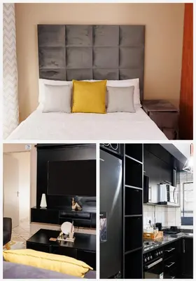 a bedroom with a large bed and a kitchen at Pamuzinda Airbnb at Urban Cove in Nelspruit