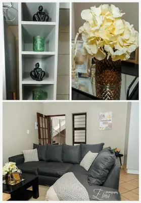 a living room with a couch and a vase of flowers at Pamuzinda Airbnb at Urban Cove in Nelspruit
