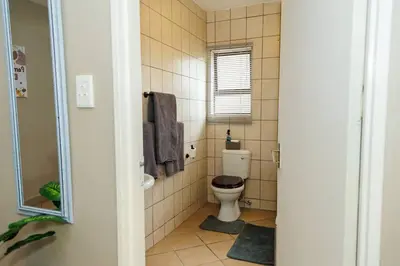 a small bathroom with a toilet and a window at Pamuzinda Airbnb at Urban Cove in Nelspruit
