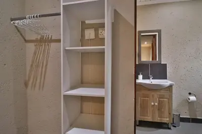 a bathroom with a sink and a mirror at Lion Den in Marloth Park