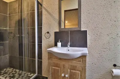 a bathroom with a sink and a shower at Lion Den in Marloth Park