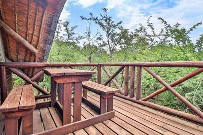 a wooden porch with a bench on a wooden deck at Leopard Chalet - Solar System in Marloth Park
