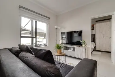 a living room with a couch and a television at Smartz Apartment312 in Midrand