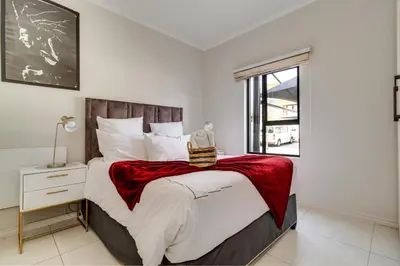 a bedroom with a large bed and a window at Smartz Apartment312 in Midrand