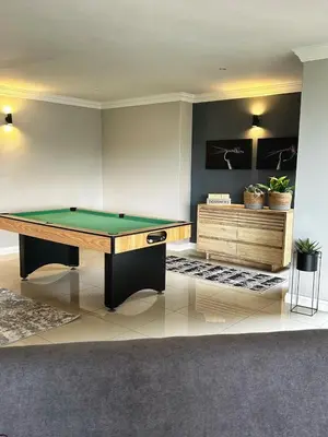 a billiard table in a room with at Waterfall House in Dullstroom
