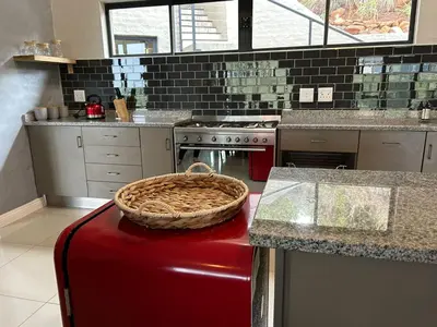 a kitchen with a basket on top of a counter at Waterfall House in Dullstroom