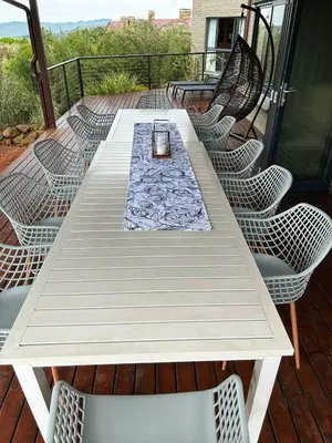 a white table and chairs on a deck at Waterfall House in Dullstroom