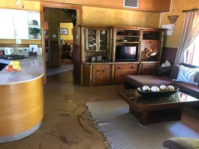 a living room with a couch and a table at Golf View Guest House in Musina