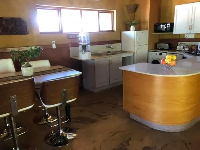 a kitchen with a large island in the middle at Golf View Guest House in Musina