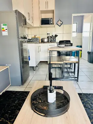 a kitchen with a table with a candle on it at Charming Wallet Friendly Apartment in Polokwane