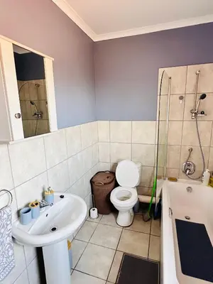 a bathroom with a sink and a toilet and a shower at Charming Wallet Friendly Apartment in Polokwane
