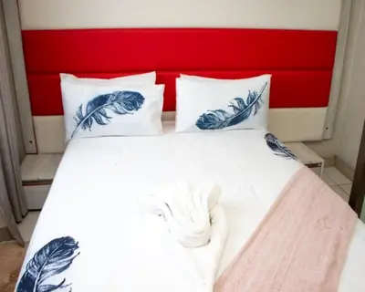 a bed with two blue and white pillows on it at Boeketlong Lodge in Jane Furse