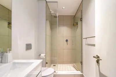 a bathroom with a shower and a toilet and a sink at AlimamaSpaces The Moksit Suite Ellipse in Midrand