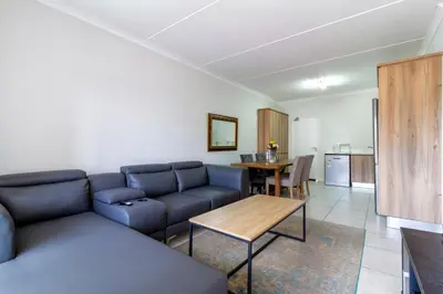 a living room with a couch and a table at Lovely 2 bed @TheBlyde in Pretoria