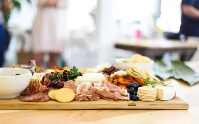 a plate of cheese and meats and other food on a table at Riboville Boutique Hotel And Restaurant in Midrand