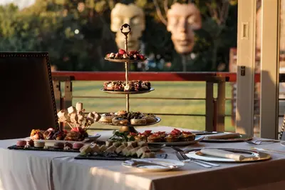 a table with plates of food on top of it at Riboville Boutique Hotel And Restaurant in Midrand