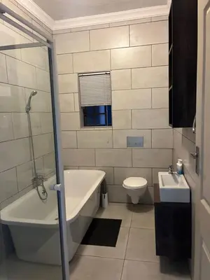 a bathroom with a tub and a toilet and a sink at THORNHILL ESTATE in Polokwane