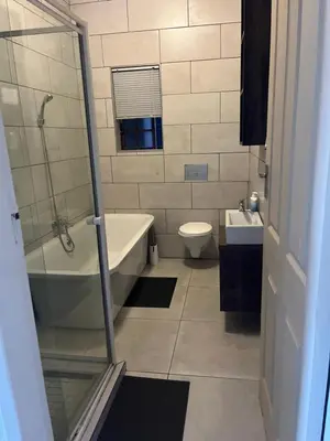 a bathroom with a tub and a toilet and a sink at THORNHILL ESTATE in Polokwane