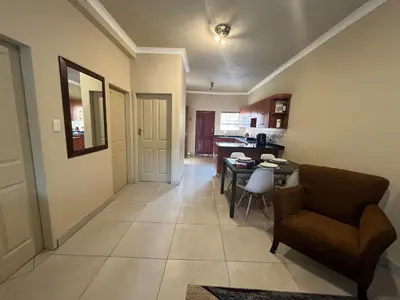 a living room with a couch and a table at THORNHILL ESTATE in Polokwane