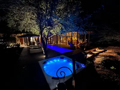 a backyard with a small swimming pool at night at Villa Kudu - Exclusive and Serviced Safari Villa near Kruger Park in Hoedspruit