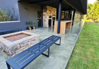 a blue bench sitting outside of a house at Walkersons 96 - NinetySix on Valley View in Dullstroom