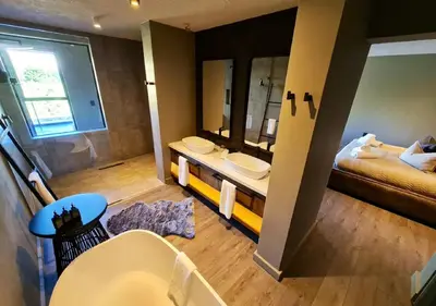 a bathroom with two sinks and a large mirror at Walkersons 96 - NinetySix on Valley View in Dullstroom