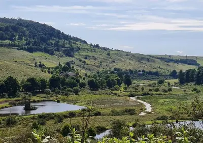 a view of a valley with a river and a mountain at Walkersons 96 - NinetySix on Valley View in Dullstroom