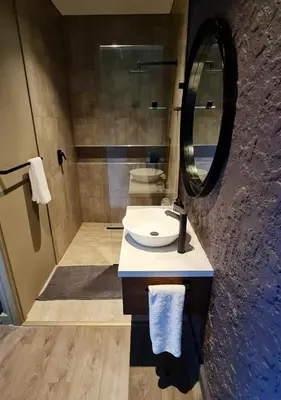 a bathroom with a sink and a mirror at Walkersons 96 - NinetySix on Valley View in Dullstroom