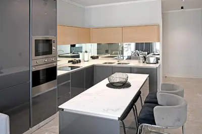 a kitchen with a table and chairs in it at Thango Res Ellipse Waterfall. in Midrand