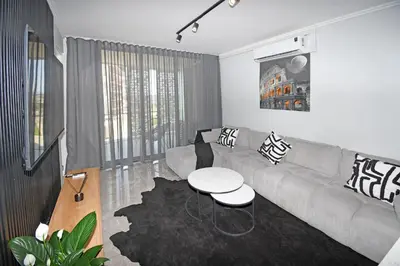 a living room with a couch and a table at Thango Res Ellipse Waterfall. in Midrand