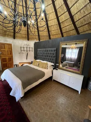 a bedroom with a large bed and a mirror at Armonia in Ermelo