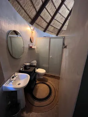 a bathroom with a sink and a toilet and a mirror at Armonia in Ermelo