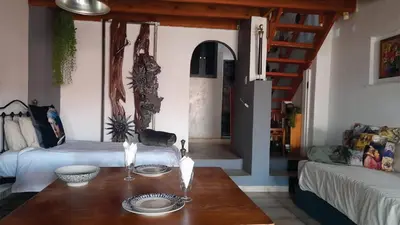 a living room with a table and a couch at Gadute Haven - Luxury Apartment in Pretoria