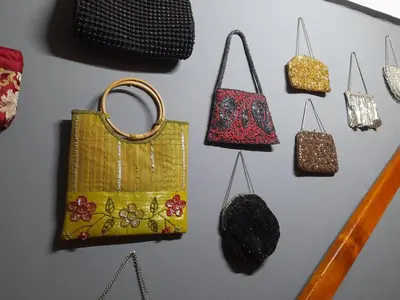 a group of purses and handbags hanging on a wall at Gadute Haven - Luxury Apartment in Pretoria