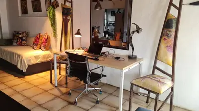 a room with a desk with a laptop and a chair at Gadute Haven - Luxury Apartment in Pretoria
