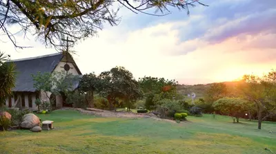 a church in a field with a grass yard at eBundu Lodge in White River