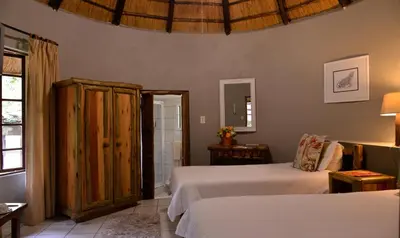 a bedroom with two beds and a window at eBundu Lodge in White River