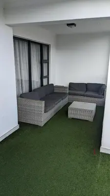 a living room with two couches and green carpet at The Blyde 1408 in Pretoria