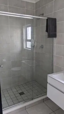 a shower with a glass door in a bathroom at The Blyde 1408 in Pretoria