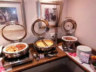 a buffet with three dishes of food on a counter at Road Lodge Centurion in Centurion